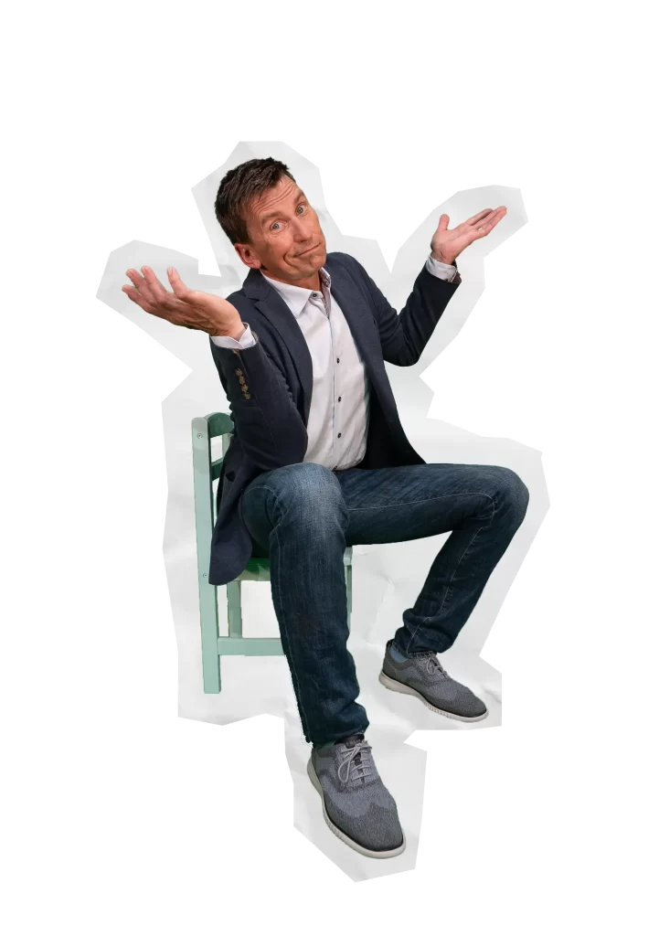 man sitting on a small chair gesturing "whoops"